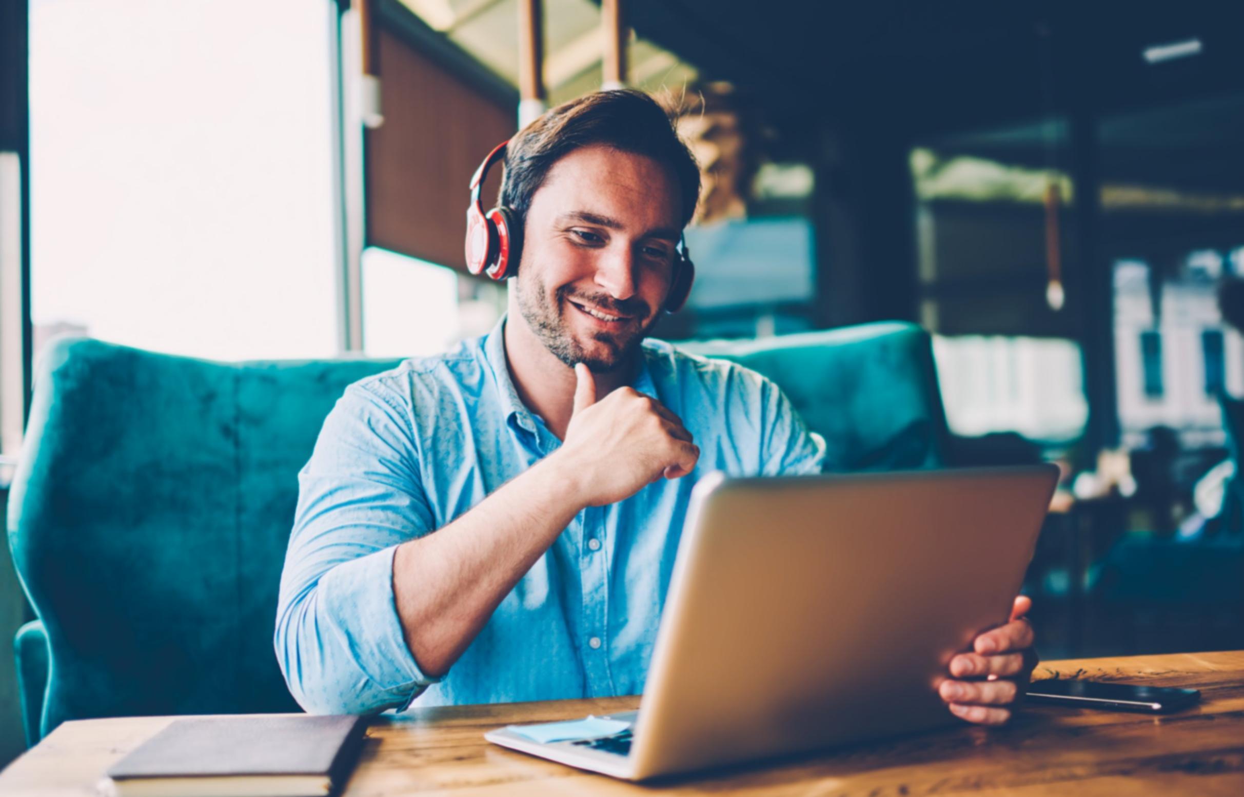 Person reviewing budget documents with calculator and laptop